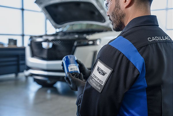 image of a mechanic doing an oil change